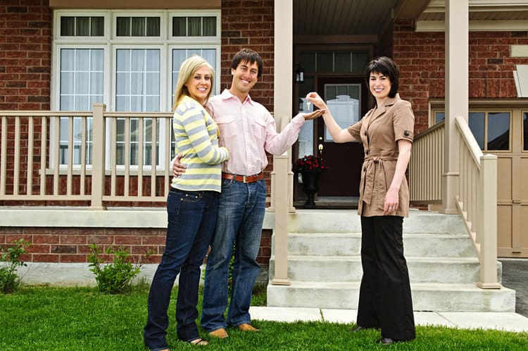 Happy couple with real estate agent Mortgages